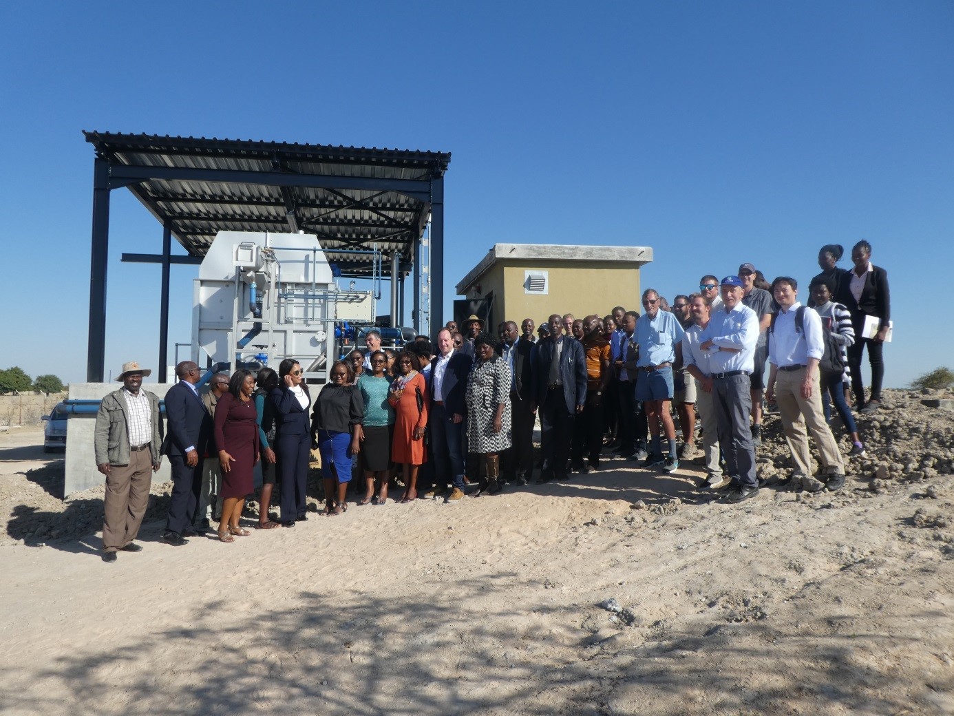 Group photo of the participants of the 3rd Wastewater Treatment Plant Neighborhood Meeting in June 2018 in Outapi, Namibia, taken in front of the wastewater pretreatment facilities.